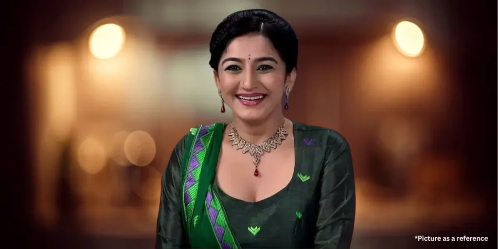 Neha Mehta in a green traditional outfit with a silver necklace and earrings.