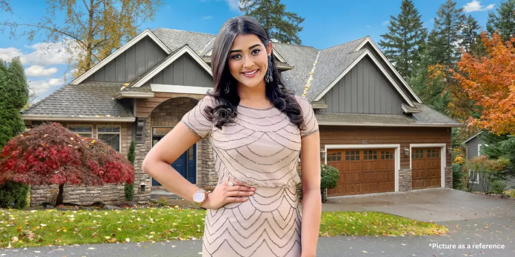 Pooja Jhaveri in a beige dress, posing in front of a modern house.