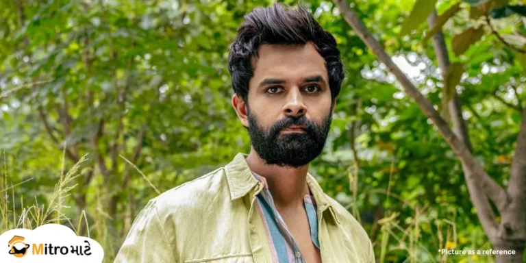 A Gujarati actor, Yash Soni, wearing a shirt with stylish hair and a beard. There are natural views surrounding the actor. On the left bottom side, there is a MitroMate brand logo on a cloud shape.