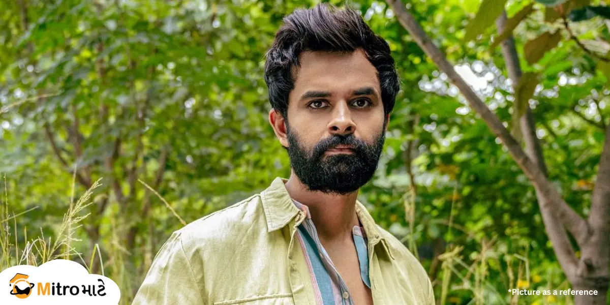 A Gujarati actor, Yash Soni, wearing a shirt with stylish hair and a beard. There are natural views surrounding the actor. On the left bottom side, there is a MitroMate brand logo on a cloud shape.