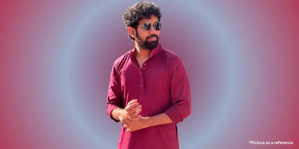 Gujarati actor Mitra Gadhvi, wearing a maroon kurta and sunglasses posing confidently on a pink and blue gradient background