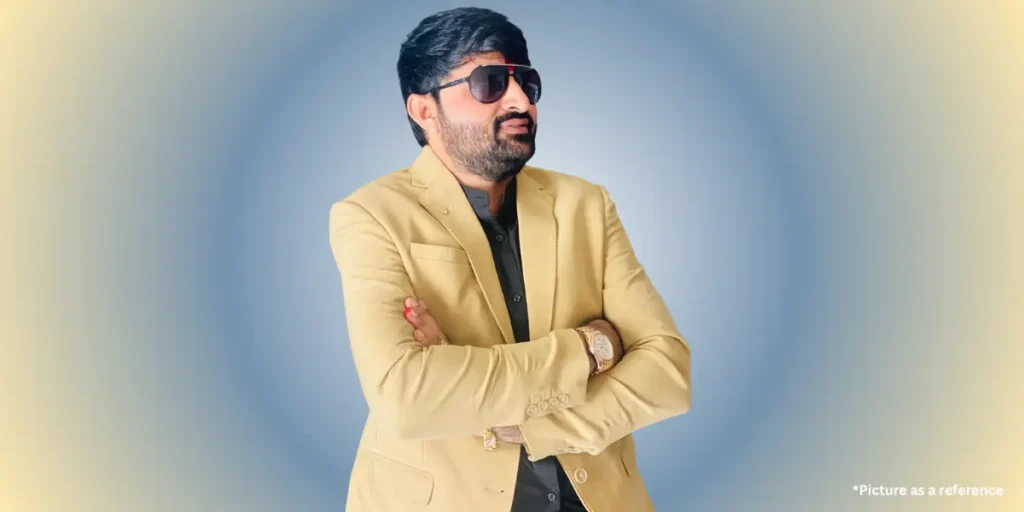 Devayat Khavad is wearing a blazer on a colorful gradient background.