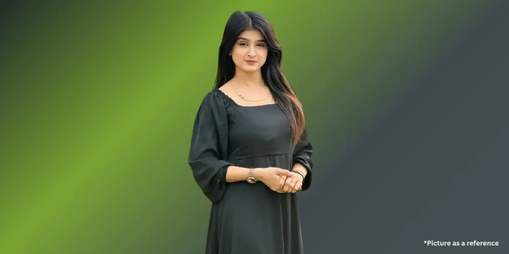 Geet Thakkar is posing in a simple black square-neck knee-length dress with balloon sleeves.