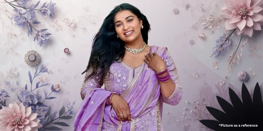 Actress Chhaya Thakor is posing in a lavender-purple embroidered Punjabi suit with matching bangles and necklace.