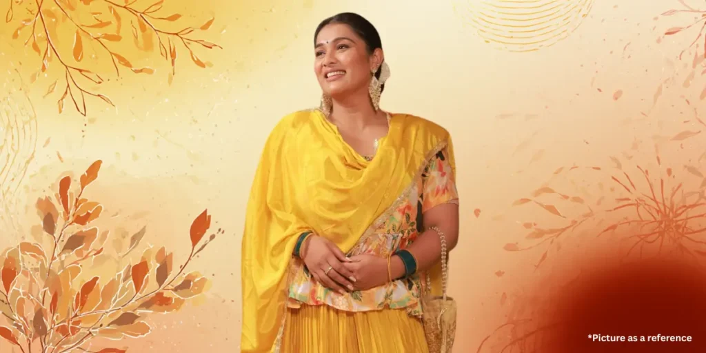 Indian and Gujarati actress Chhaya Thakor in a vibrant yellow silk saree and heavy jhumka earrings.
