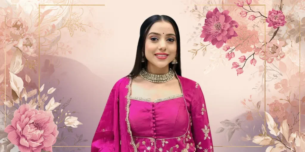 A smiling woman singer, Kinjal Rabari, in a vibrant pink embroidered tunic with a colorful patterned lower.