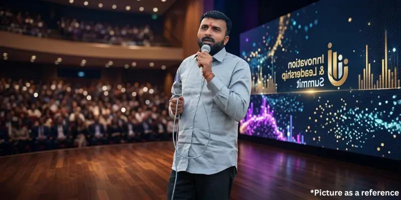 Indian politician Raju Karpada speaking at an summit in a professional auditorium setting.