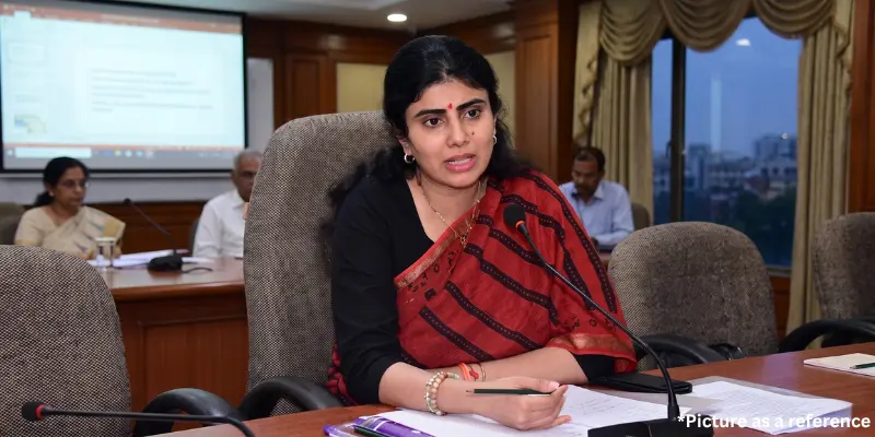 Rivaba Jadeja speaking into a microphone during a presentation in a conference room.
