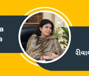 Politician Rivaba Jadeja is sitting in an office setting, and her name is written in Gujarati and English.