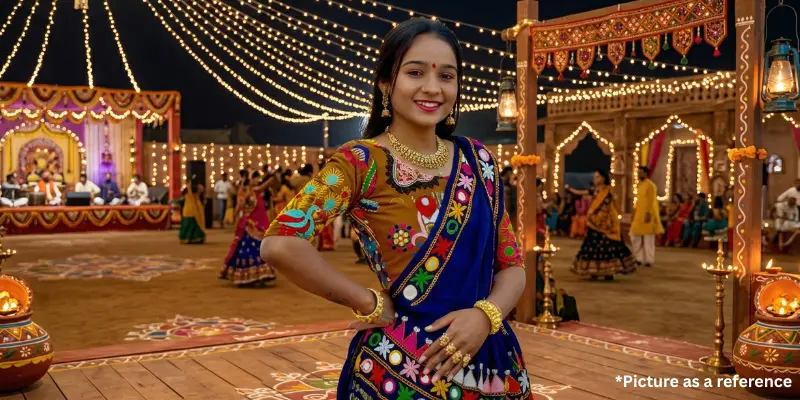 Gujarati singer Rinku Bharwad in a colorful traditional chaniya choli, posing at an outdoor night cultural event.